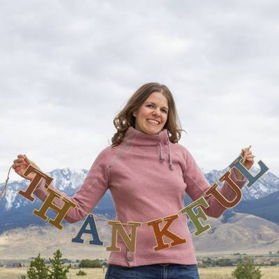 Katie with thankful banner